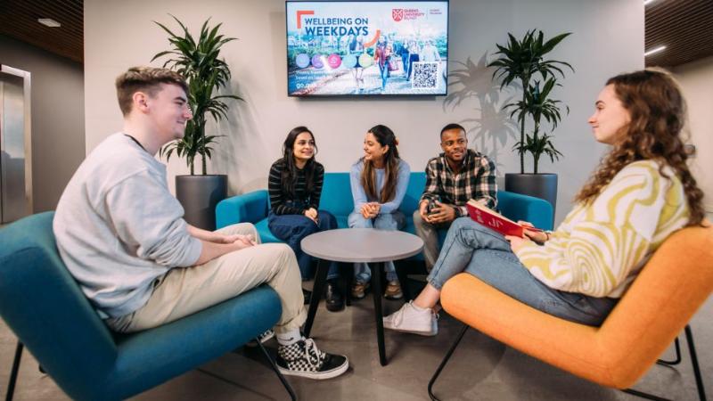 students sitting round a table chatting